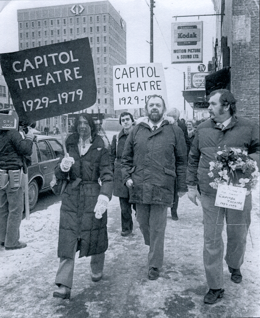 Black-veil-wearing Peggy Sarjeant, left, and her husband Bill Sarjeant, middle, host a public mourning of the Capitol two years after its demolition. Bill Sarjeant died in 2002. Peggy went on to lead Saskatoon's heritage community. (Saskatoon StarPhoenix)