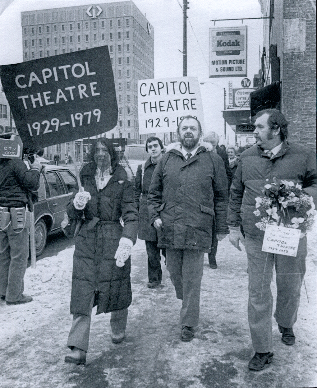 Black-veil-wearing Peggy Sarjeant, left, and her husband Bill Sarjeant, middle, host a public mourning of the Capitol two years after its demolition. Bill Sarjeant died in 2002. Peggy went on to lead Saskatoon's heritage community. (Saskatoon StarPhoenix) 