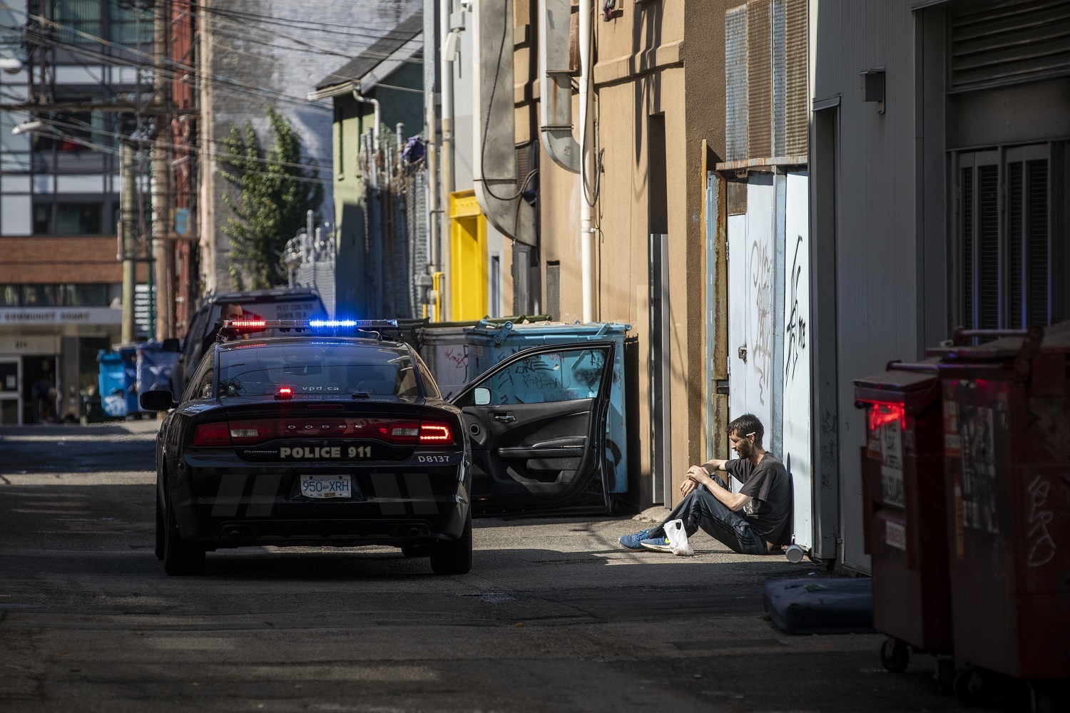 A man is detained by the Vancouver Police in the Downtown Eastside in Vancouver, British Columbia on Friday, September 6, 2019. (Ben Nelms/CBC)