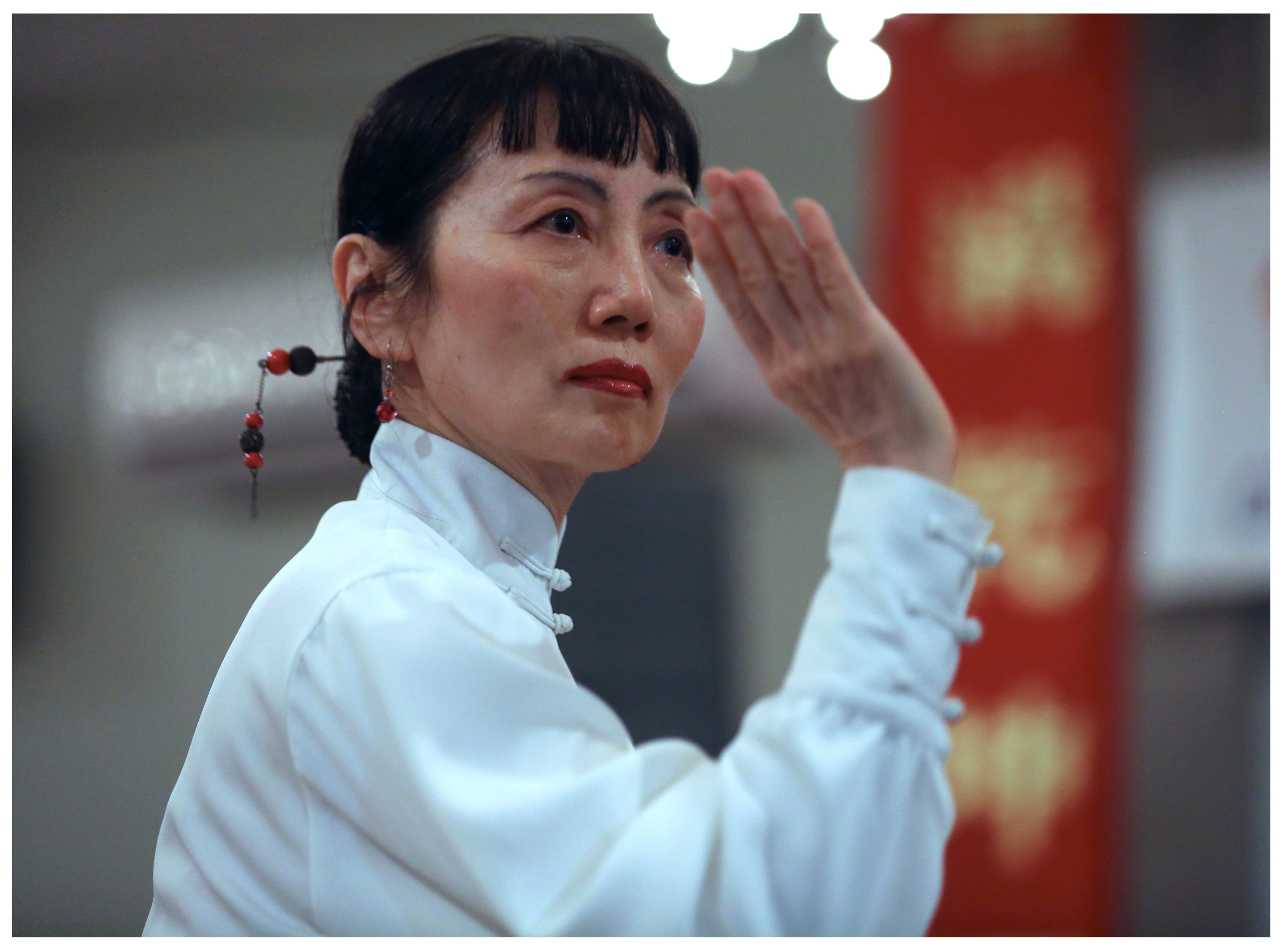 Dr. Yajing Song performs tai chi, during a program of presentations during the evening. 