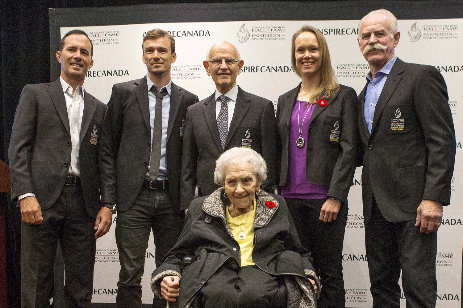 Dr. Charles Tator, centre top, at the announcement regarding his induction into the Canadian Sports Hall of Fame in Toronto, on Thursday, November 9, 2017. Dr. Tator was a 2016 Berlin consensus statement author, but is critical of its section on CTE. He is next to, from left to right, Mike Weir, Simon Whitfield, Tator, Cindy Klassen, Lanny McDonald and Kay MacBeth, sitting. (Chris Young/Canadian Press)