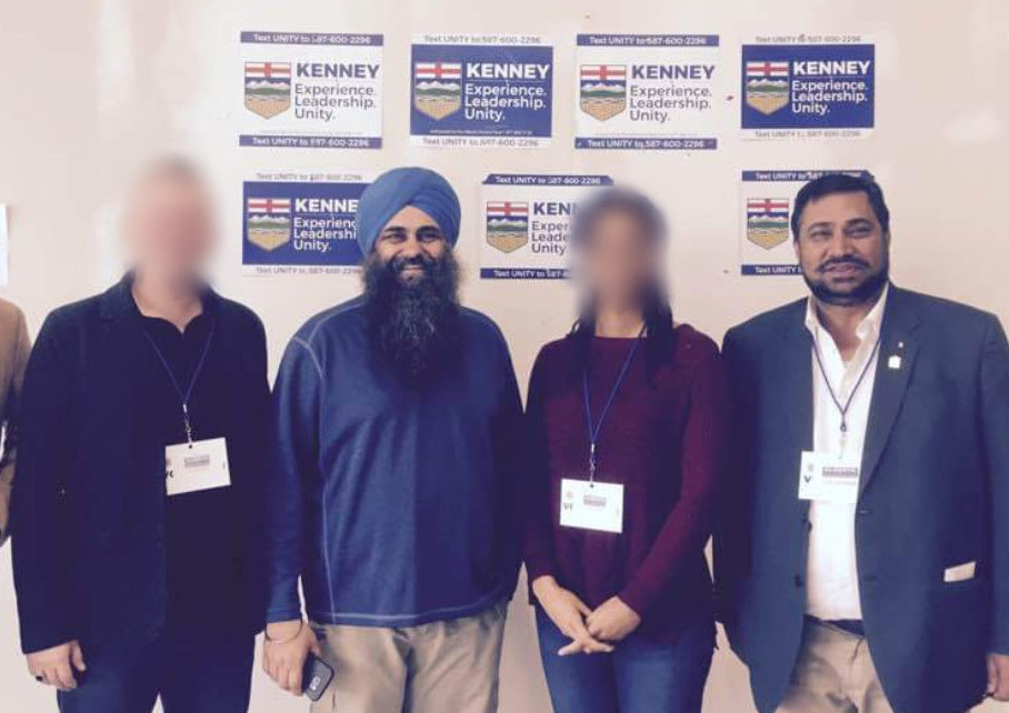 Federal Conservative candidate and former cabinet minister Tim Uppal, second from left, and former PC MLA Peter Sandhu, right, inside the kiosk on Ellerslie Road. CBC News has blurred the faces of others not mentioned in this story. (Facebook)