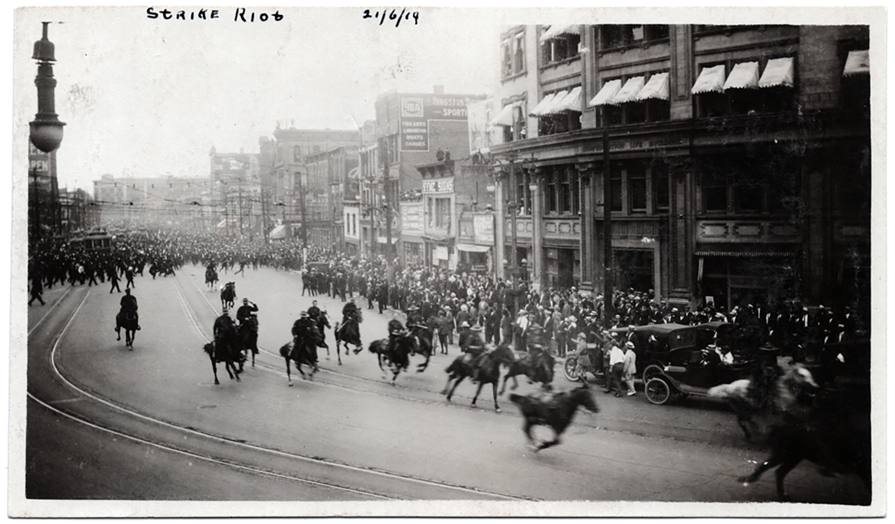 Police on horses charge around the corner of Portage Avenue and Main Street on Bloody Saturday. (William Wilson fonds/Archives of Manitoba)