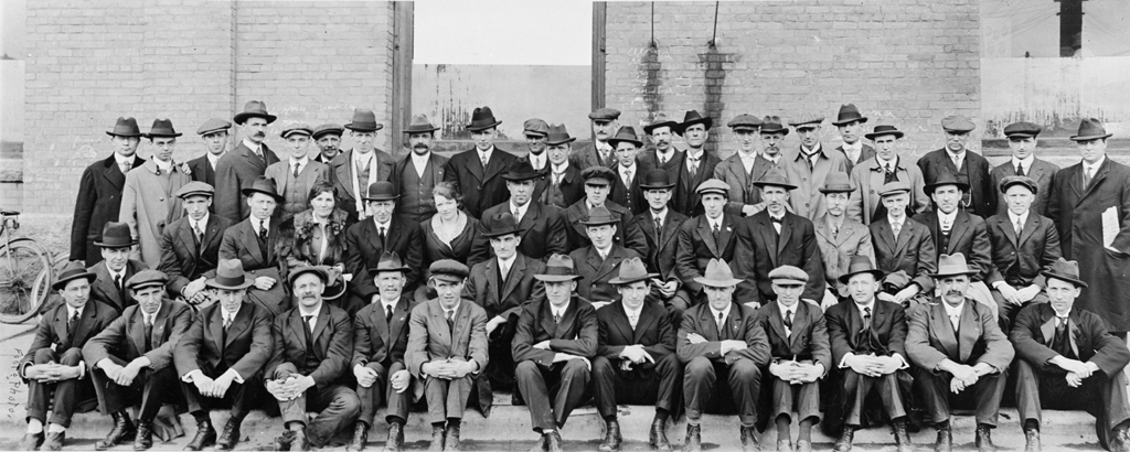 The Winnipeg General Strike Committee poses in front of a brick building in 1919. The individuals are not identified, but Helen Armstrong is in the middle row, third from the left. (Archives of Manitoba)