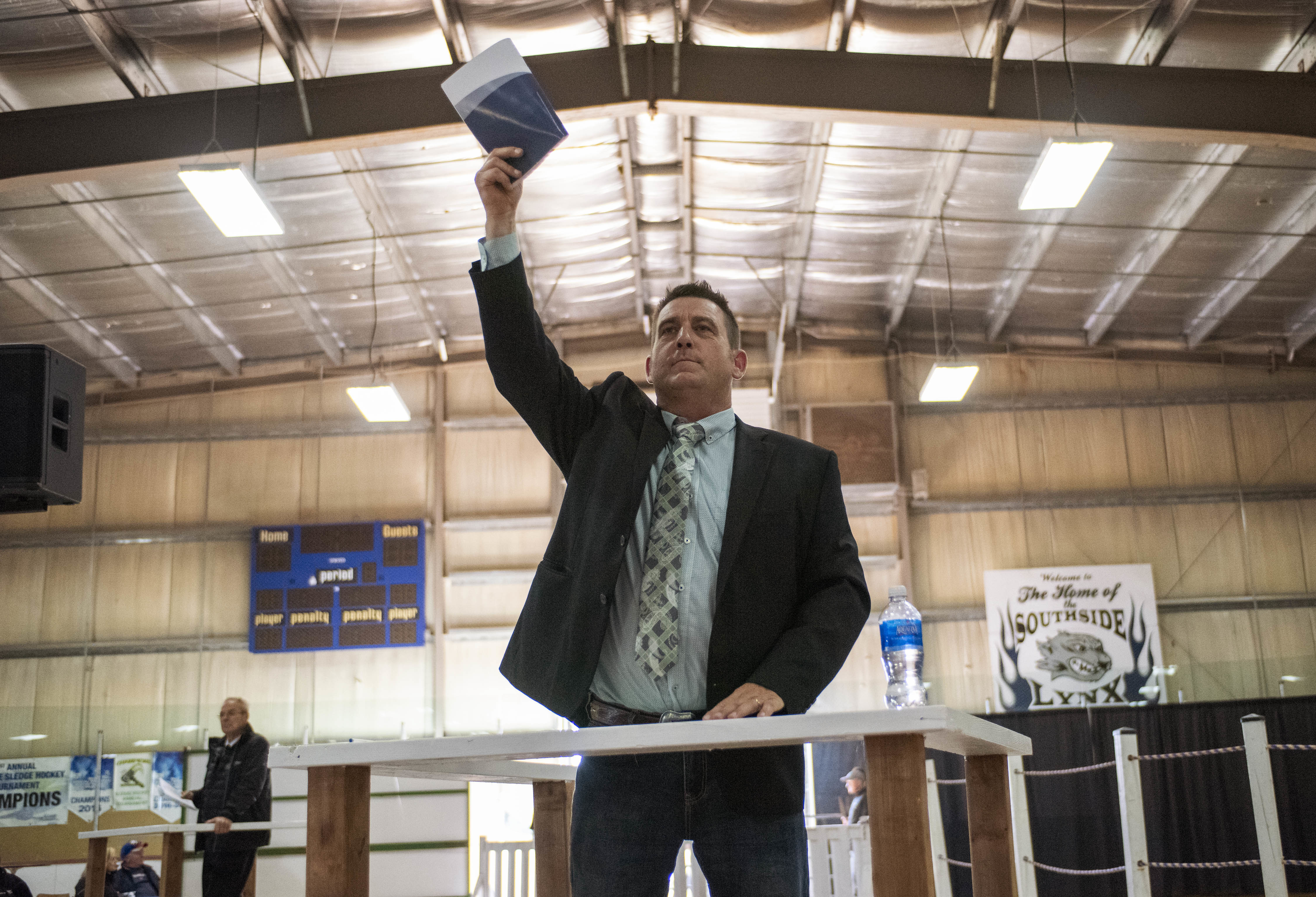 Bid spotter Tim Parker shows his enthusiasm as he lets a bidder know their bid has been noted by the auctioneer. (Brian McInnis/CBC)