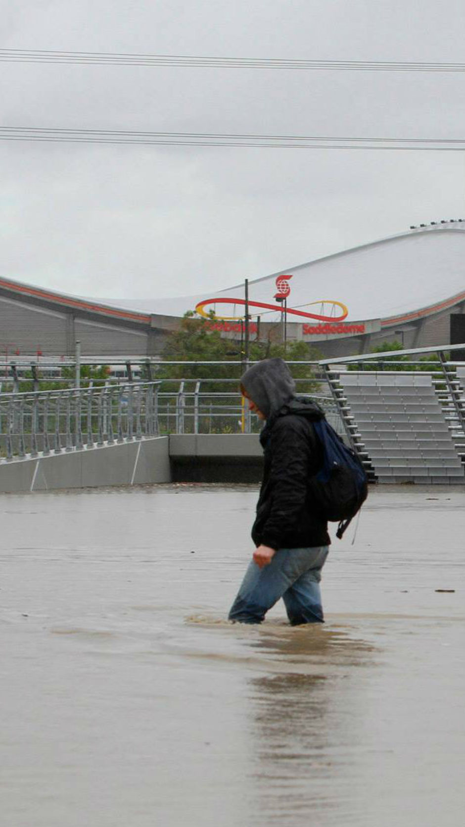 A man walks, thigh-deep in water, along Ninth Avenue in downtown Calgary during the 2013 flood.