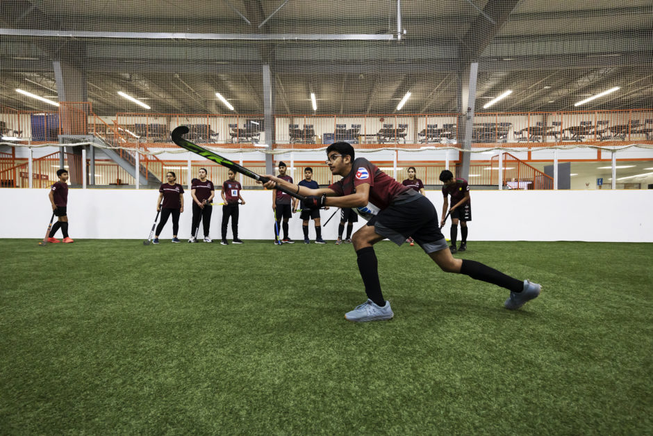 Field hockey player Rupinder Sahij Pal, 14, practices a power push, a drill to build passing skills. Players in Winnipeg rely on soccer turfs to practice indoors because the city does not have astroturf for field hockey in recreational facilities.