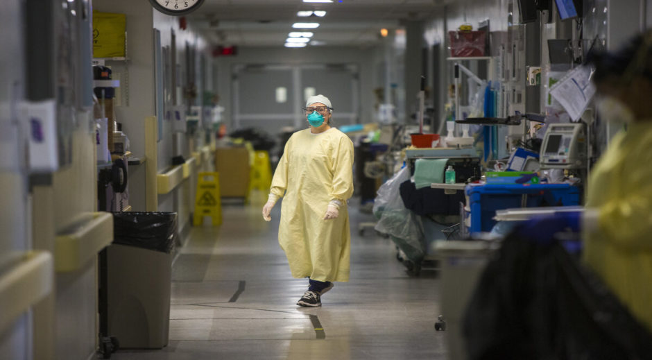 A health-care worker stands in a COVID positive unit. 