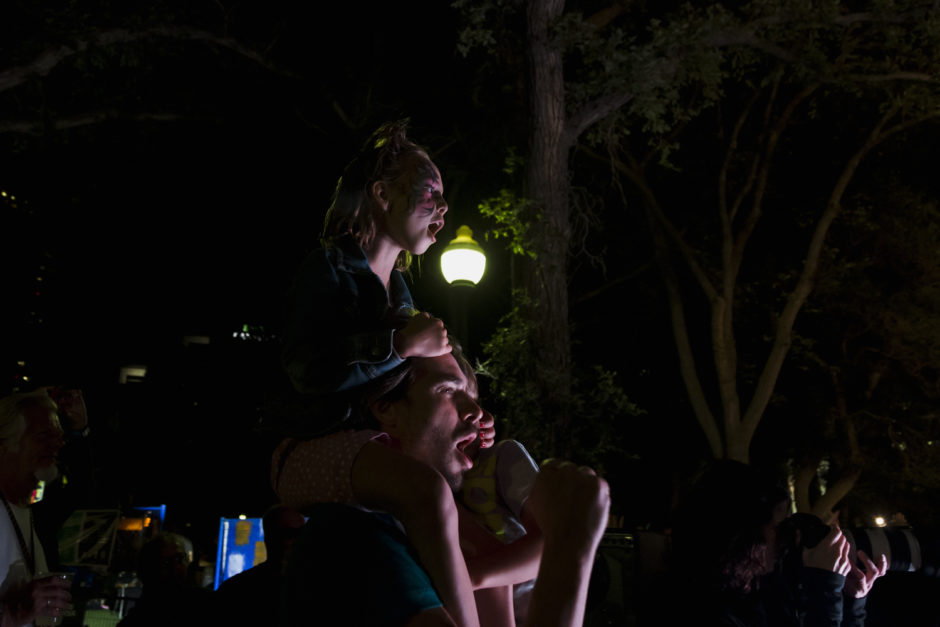 Jay Kimball and holds children as they watch the Folk Festival stage in 2016. (Carey Shaw)