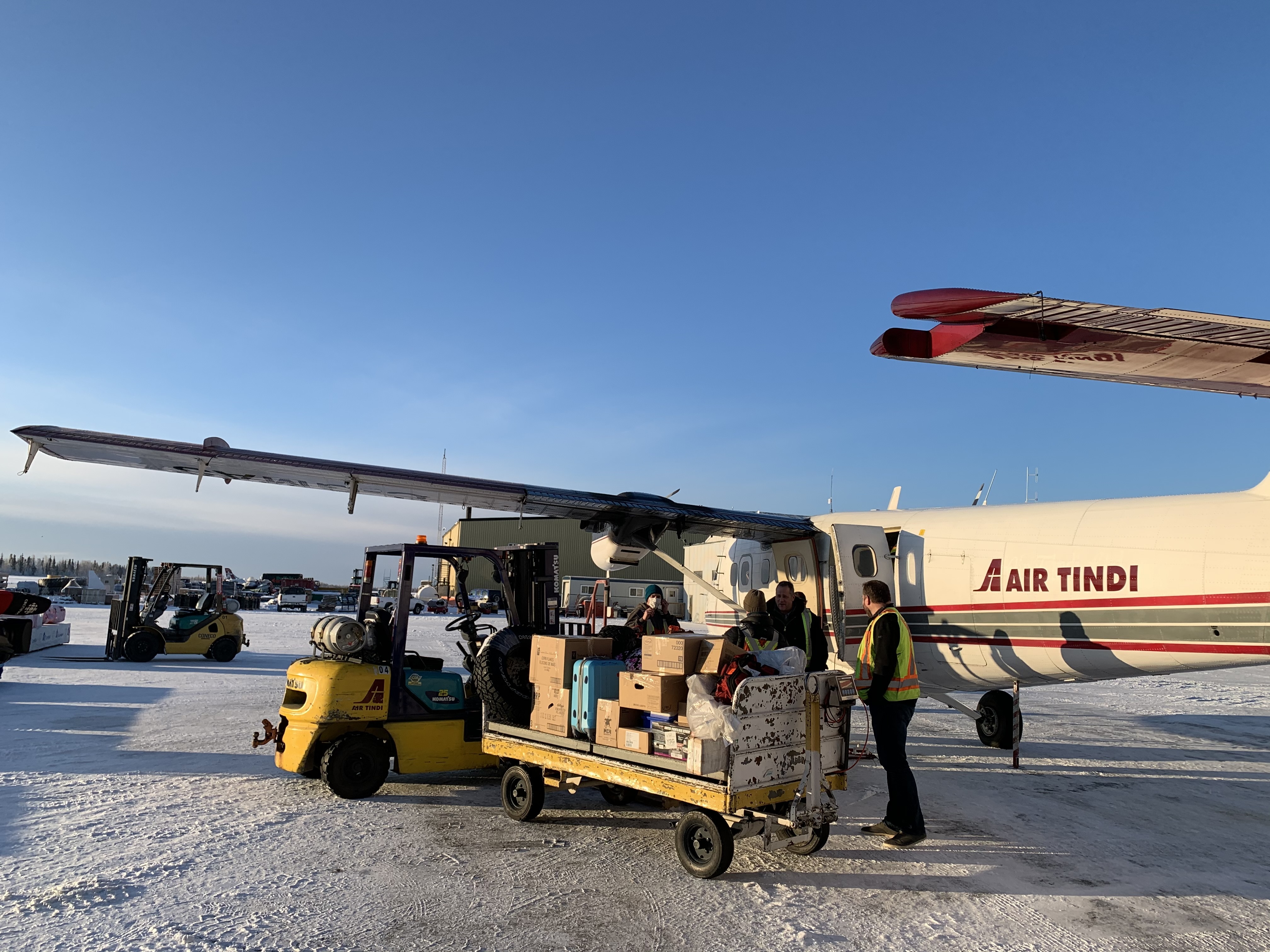 Air Tindi workers load a plane with cargo, which at times has included vehicle parts, building materials, or even livestock. (Sidney Cohen/CBC)