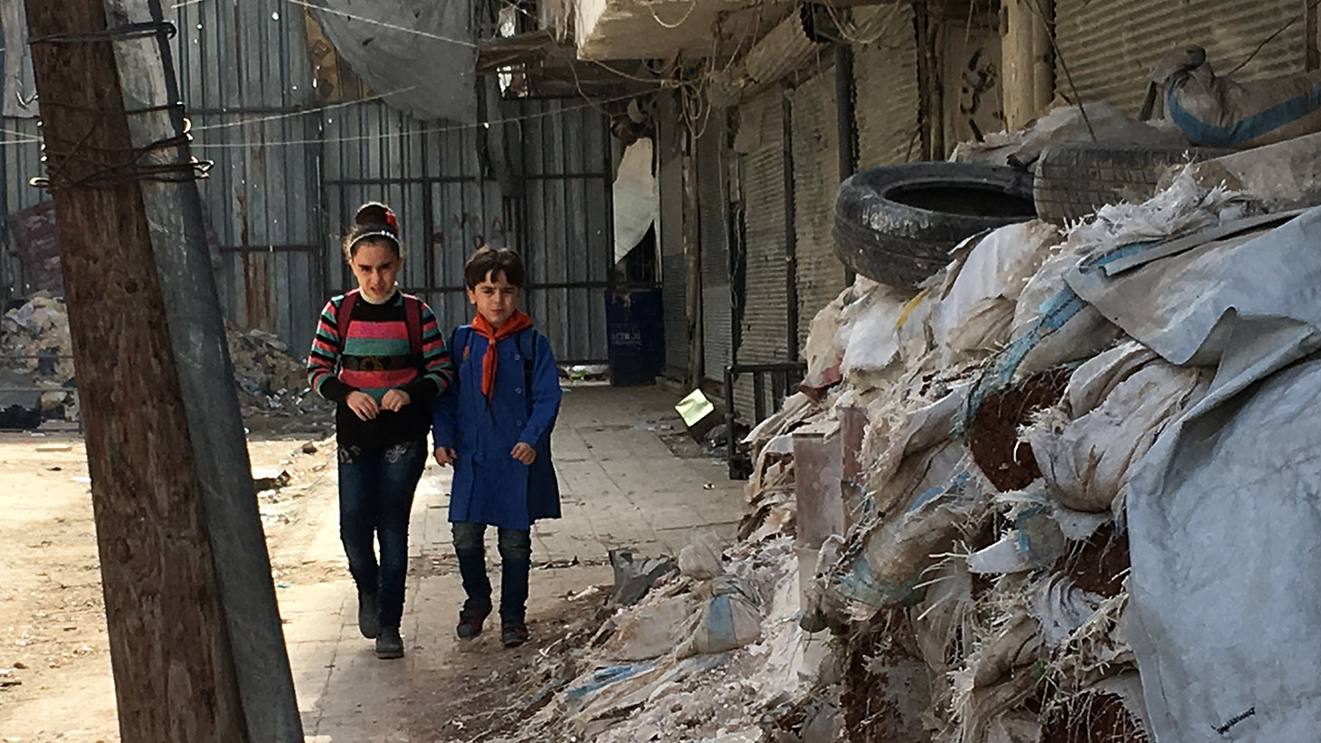 Children walking amid the rubble. (Margaret Evans/CBC)