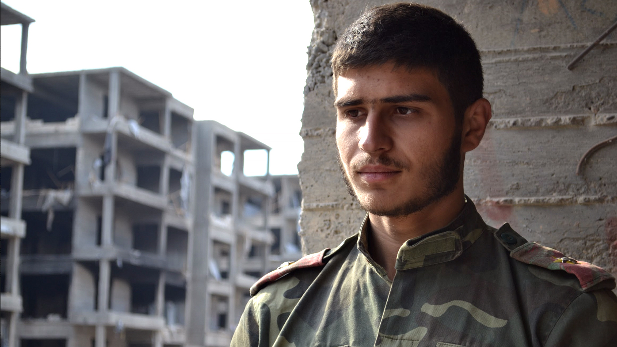 A Syrian government soldier surveys the damage. (Stephanie Jenzer/CBC)