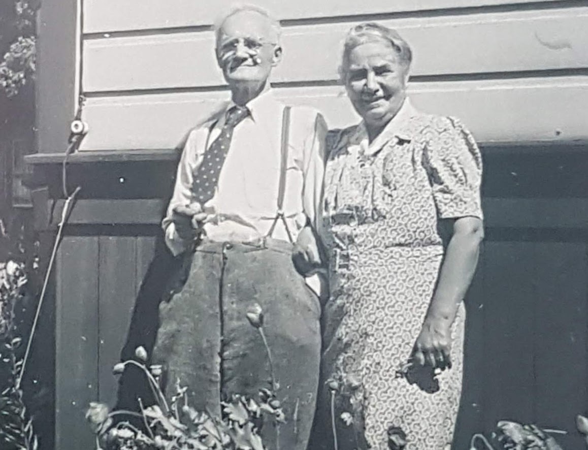 George and Helen Armstrong stand in a garden outside their house on Winnipeg's Dunkirk Drive in the 1930s. (Helen Armstrong fonds/Archives of Manitoba)