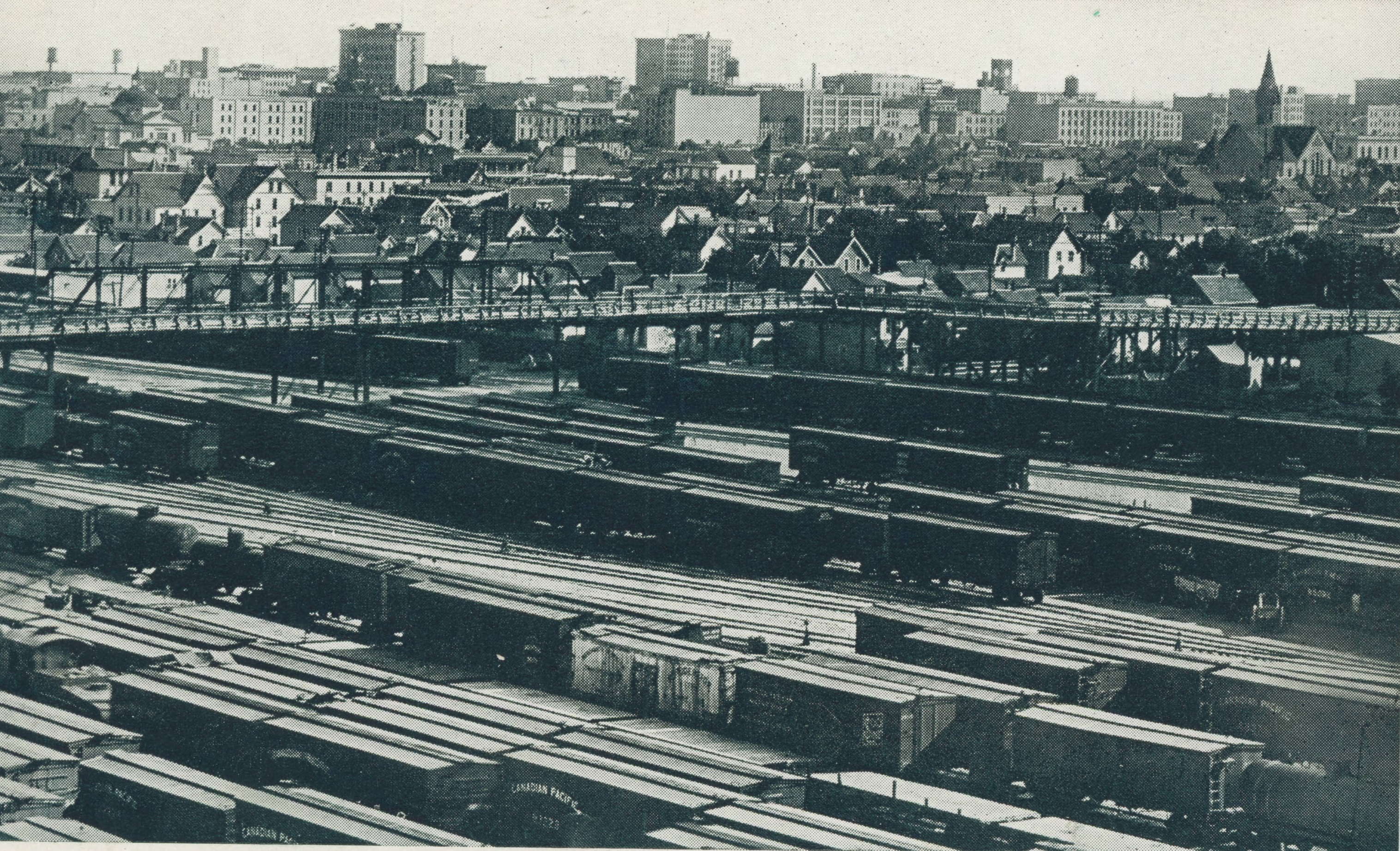 The Salter Street Bridge (now the Slaw Rebchuk Bridge) passes over the CP Rail yards in this photo taken sometime between 1904 and 1911. The photographer is in the working-class North End, which the railway cut off from downtown and wealthy south Winnipeg, where the Union Bank Tower reaches into the sky, left of centre on the horizon. Knox Presbyterian Church, now Knox United, is on the right.