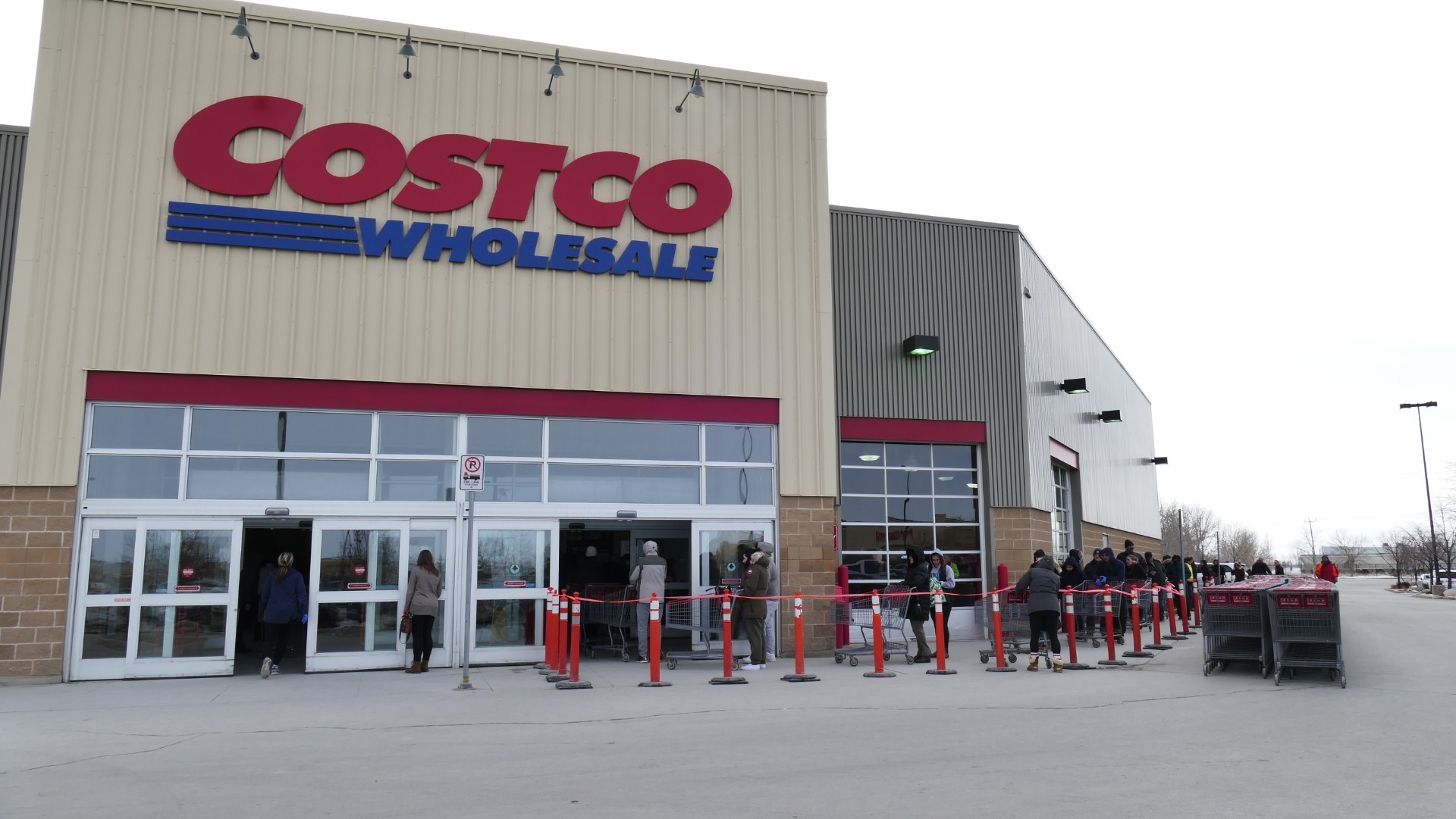 Customers wait in a lineup to go inside Costco on Kenaston Boulevard. (Darin Morash/CBC)