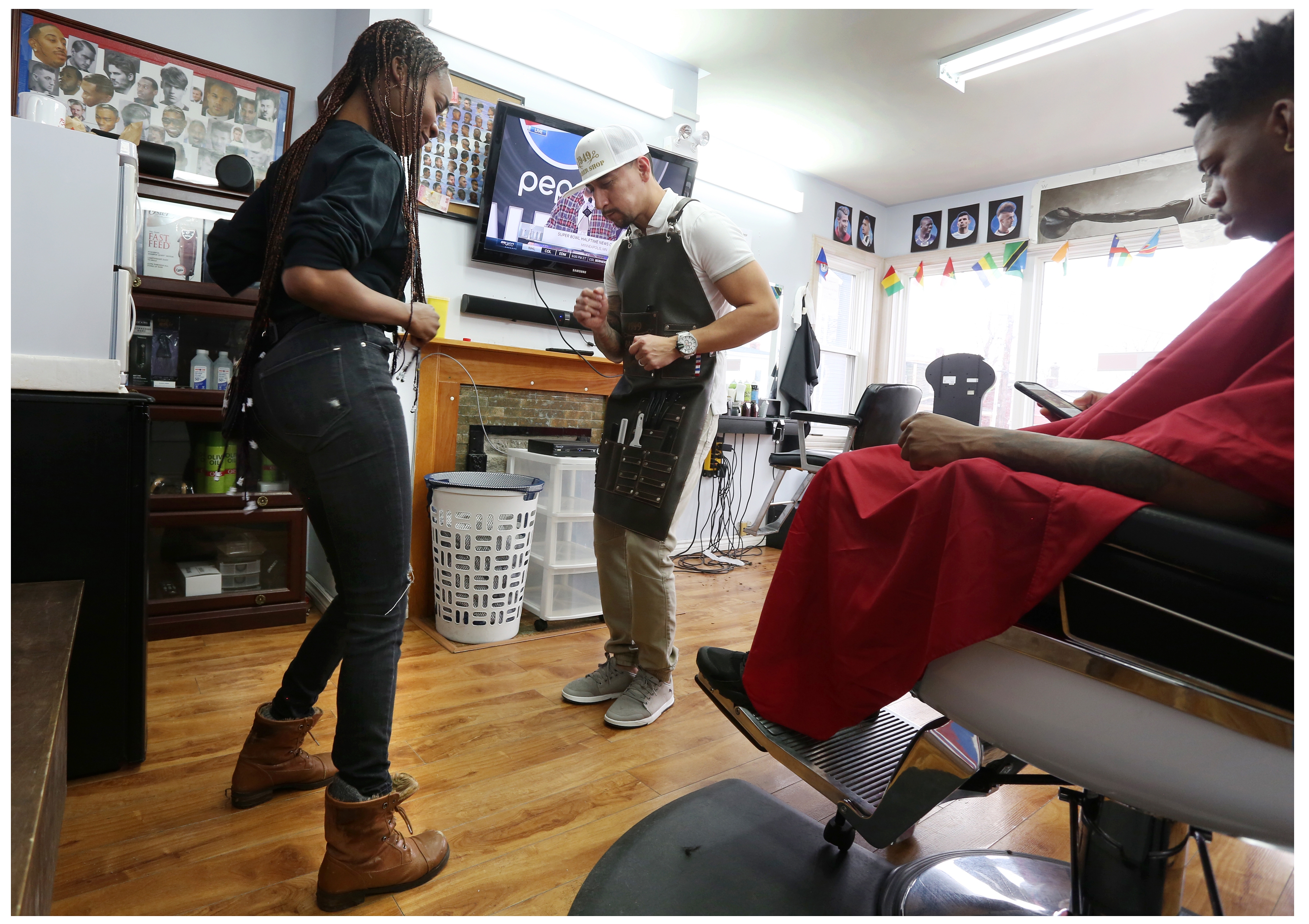 A little music lightens the mood at the barbershop. (Paul Daly) 