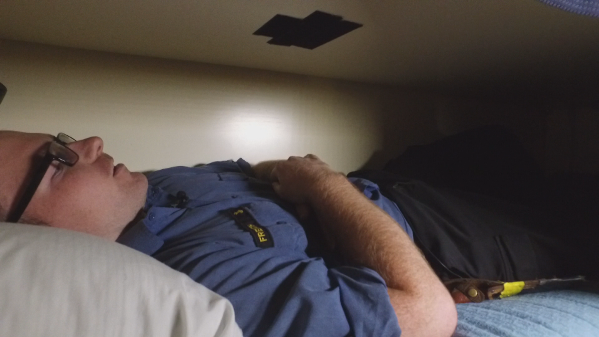 Dylan French shows how tight the quarters are in his cot. (Peter Cowan/CBC)