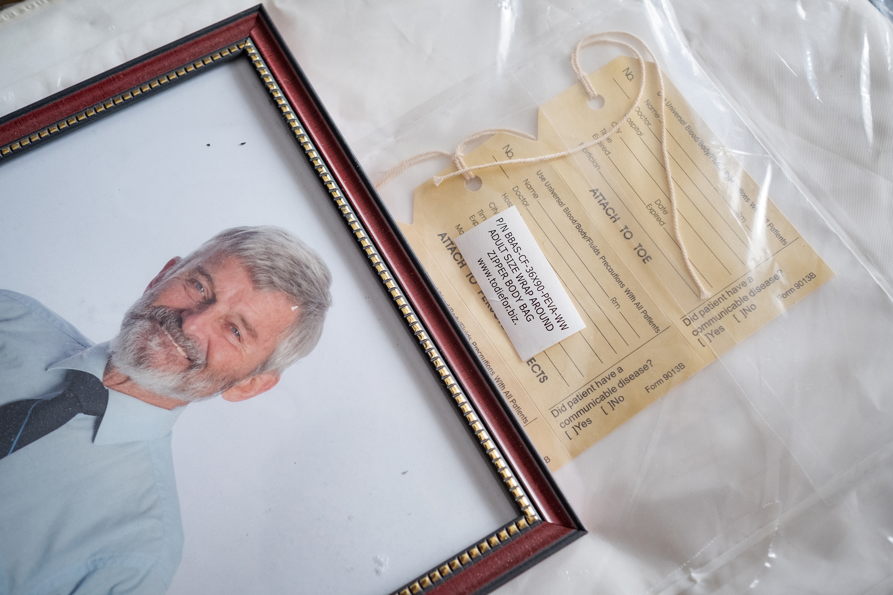 A photo of Edward Farrar, alongside the body bag that Mary has purchased for him. (Evan Mitsui/CBC)