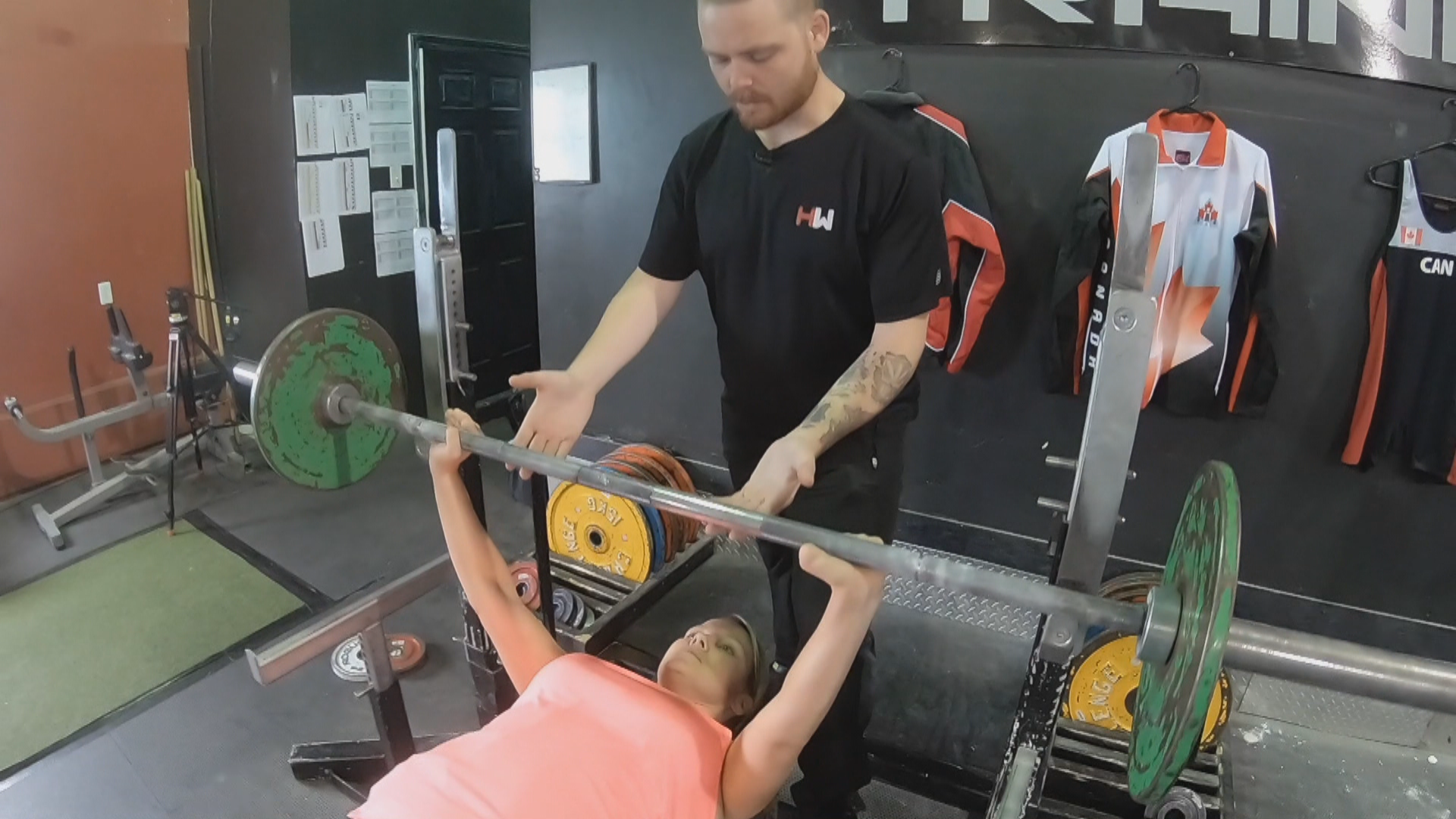 In order to do a chest press, Elaine Dodge-Lynch has to balance the bar perfectly. (Sherry Vivian/CBC)