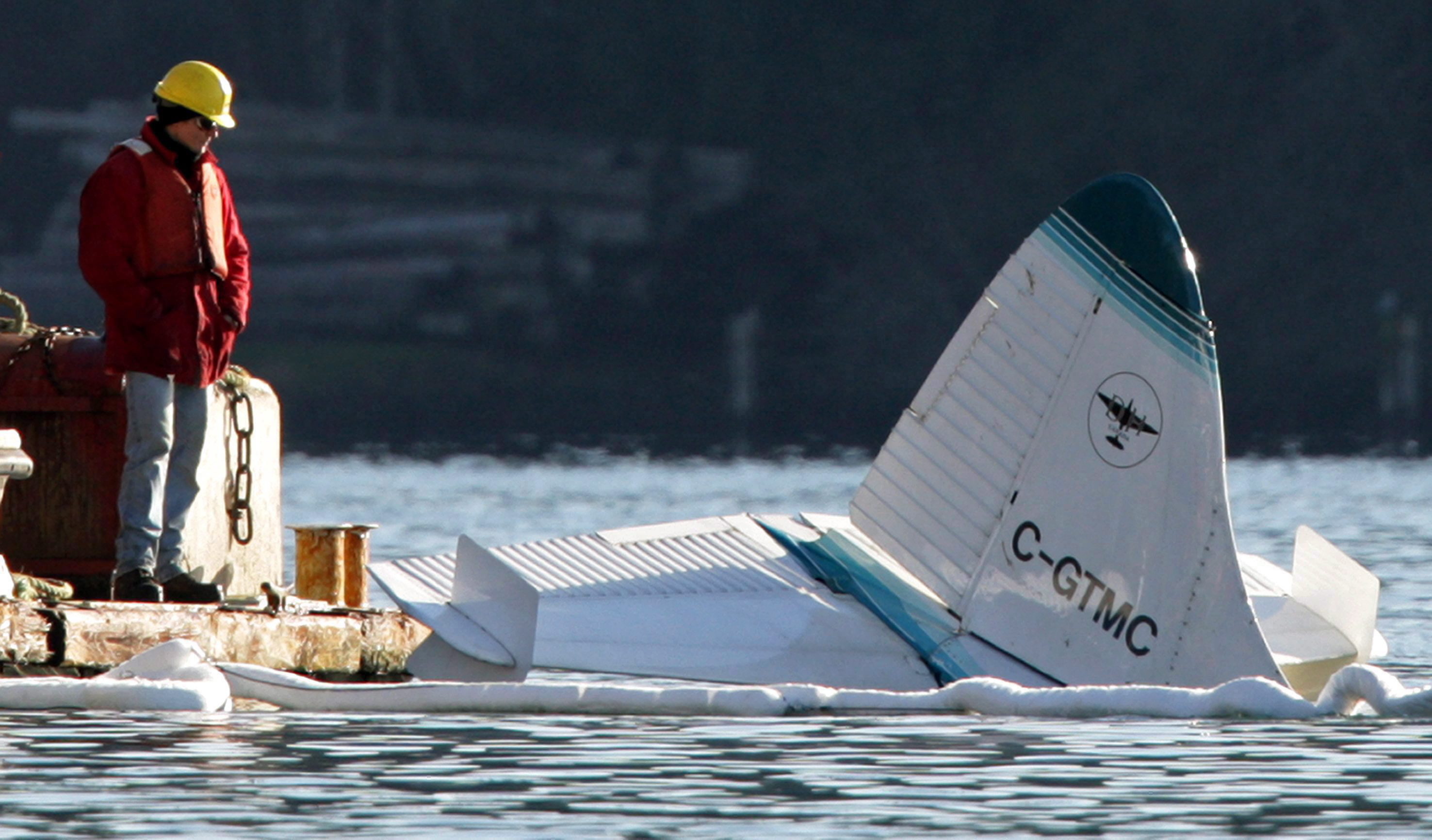 The wreckage of a float plane is lifted from the water onto a barge in Lyall Harbour at Saturna Island, B.C., on Tuesday Dec. 1, 2009. Darryl Dyck/The Canadian Press