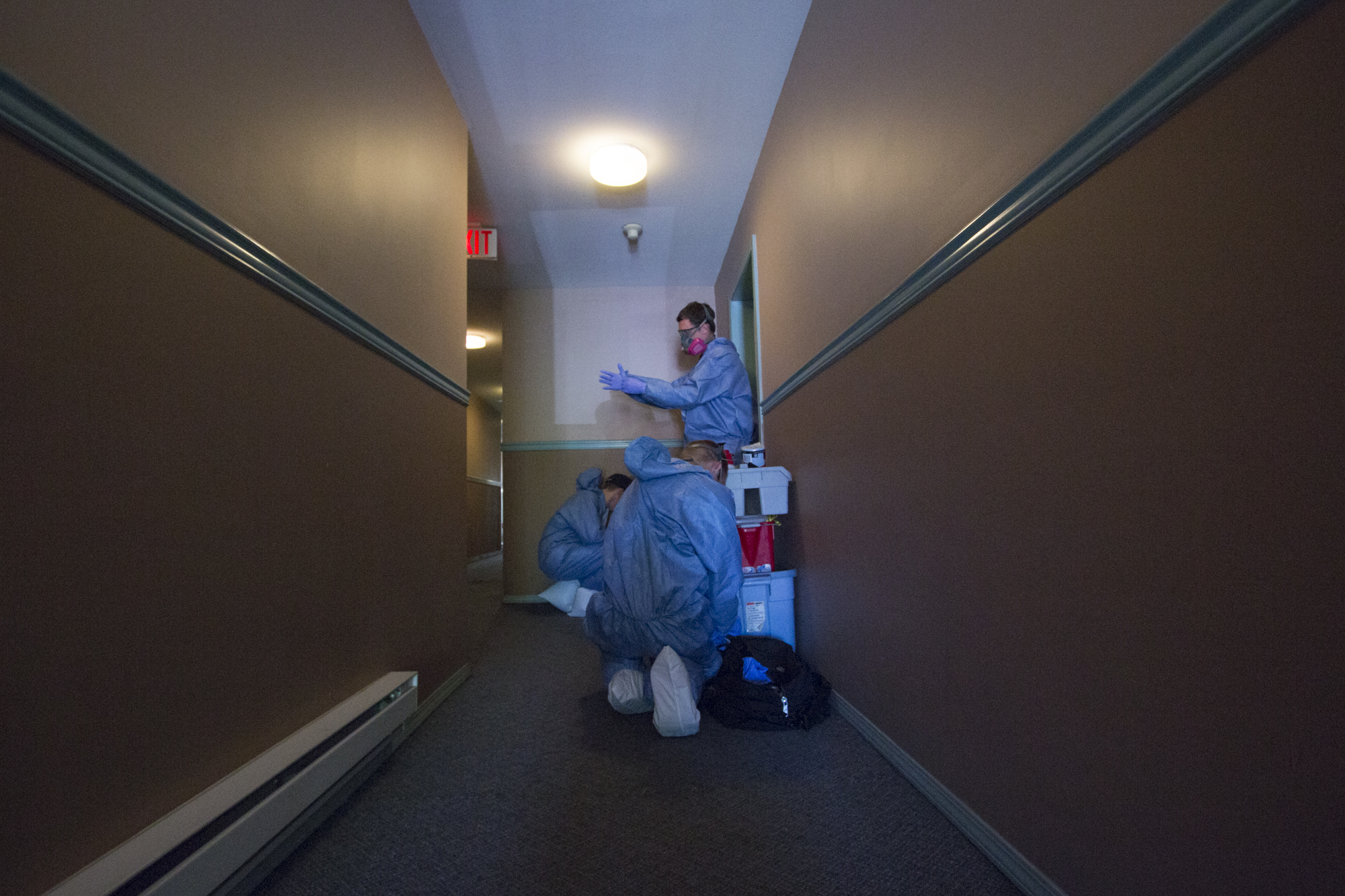 Kreklau and his team get suited up before going into the apartment to avoid cross-contamination. (Tina Lovgreen/CBC)