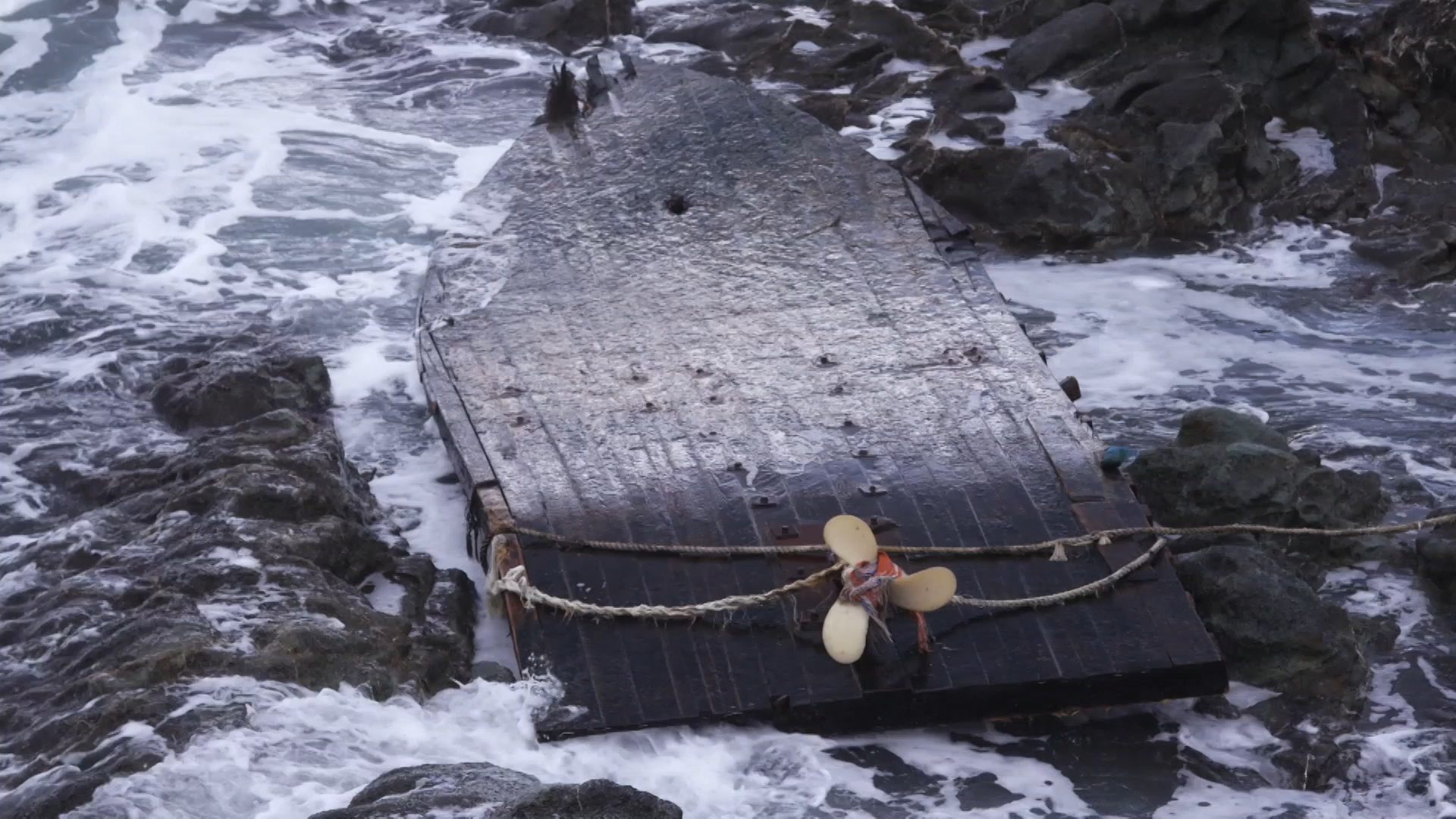 An overturned North Korean fishing boat washed up on the coast of Japan. North Korean fishermen seem to be venturing out into more dangerous waters as they get displaced by large Chinese trawlers fishing for squid in North Korean waters. (South Korea Fisheries Agency/The Outlaw Ocean Project)