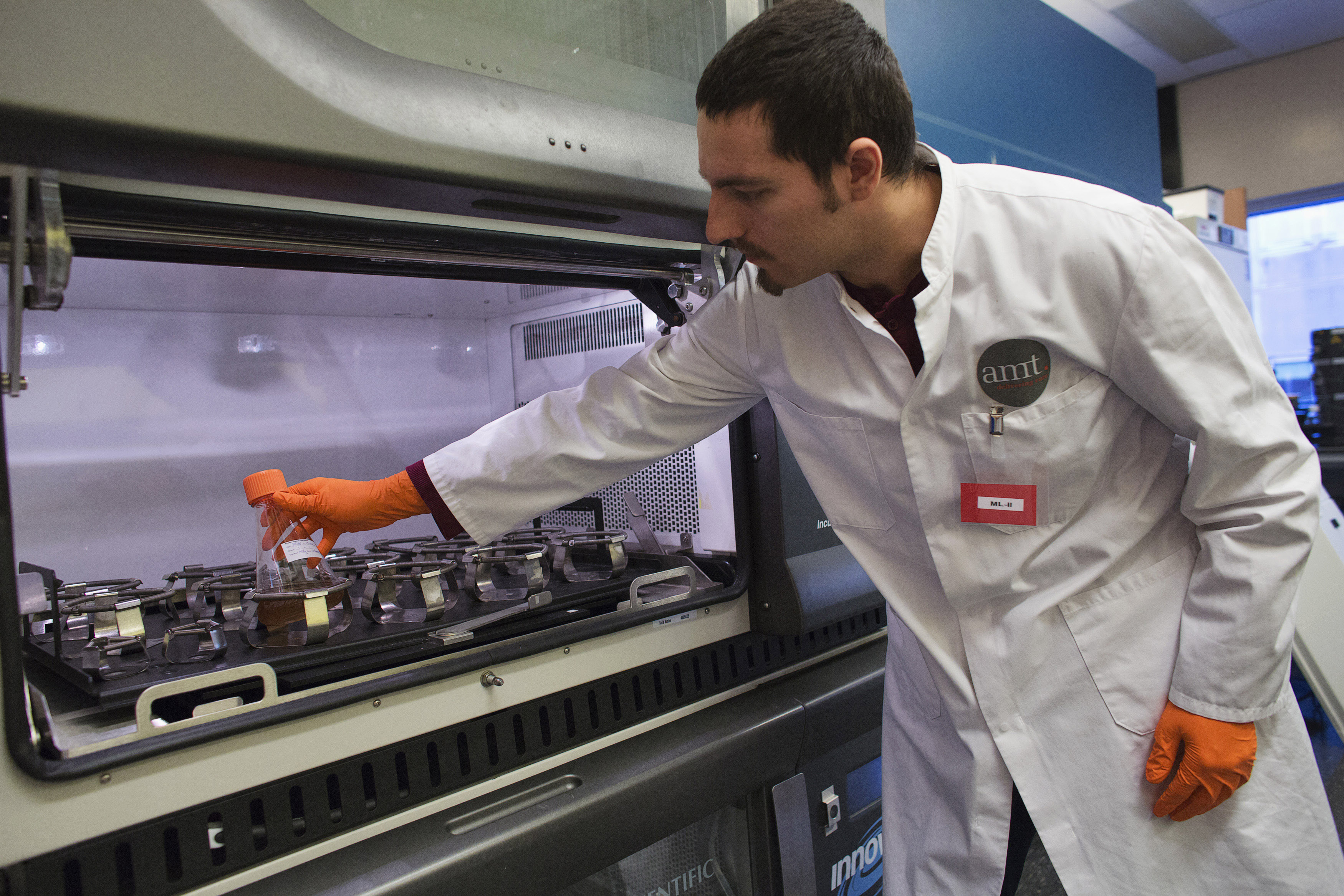 In this shot from December 2012, a uniQure bioprocessing engineer in Amsterdam shows a shaker flask of cells being used as tiny factories to produce the gene therapy drug Glybera. (Michael Kooren/Reuters)