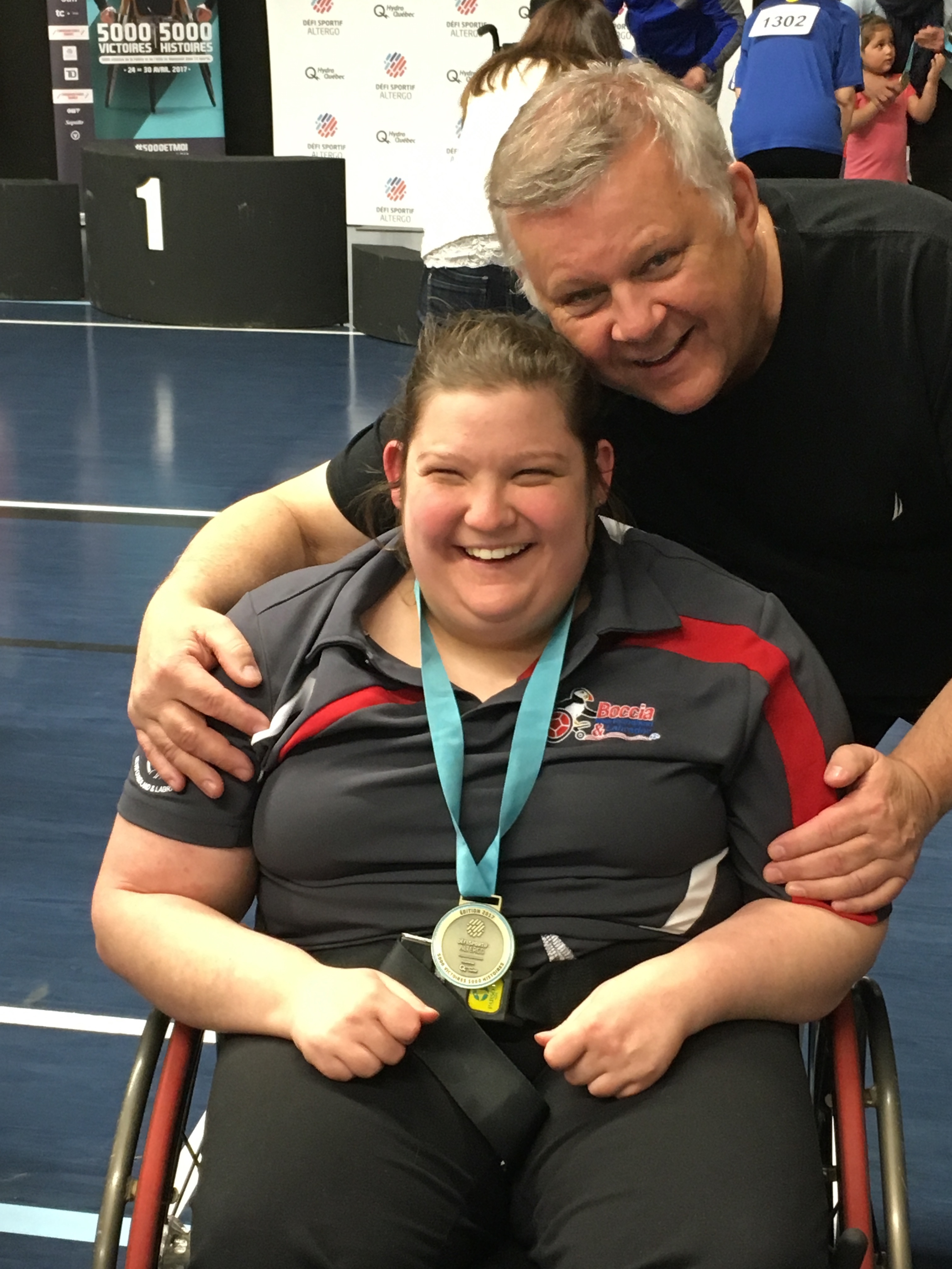 Hayley Redmond (left) and her dad, Tony Redmond (right), at a boccia competition in 2017 in Montreal, where she won gold. (Submitted by Gillian Batten)