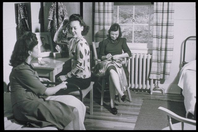 A slide from a recruitment presentation shown to young Newfoundland women, showing mill girls relaxing in their residence. Photo: Hespeler Heritage Centre.