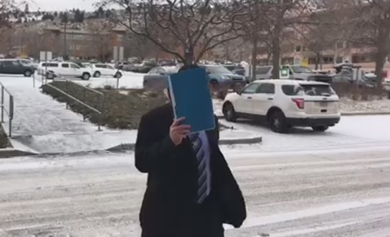 Const. Joedy Todd Henderson arrives for his sentencing in Kamloops. A provincial court judge gave him a conditional discharge for assaulting Sean Redenbach. (Jason Proctor/CBC)