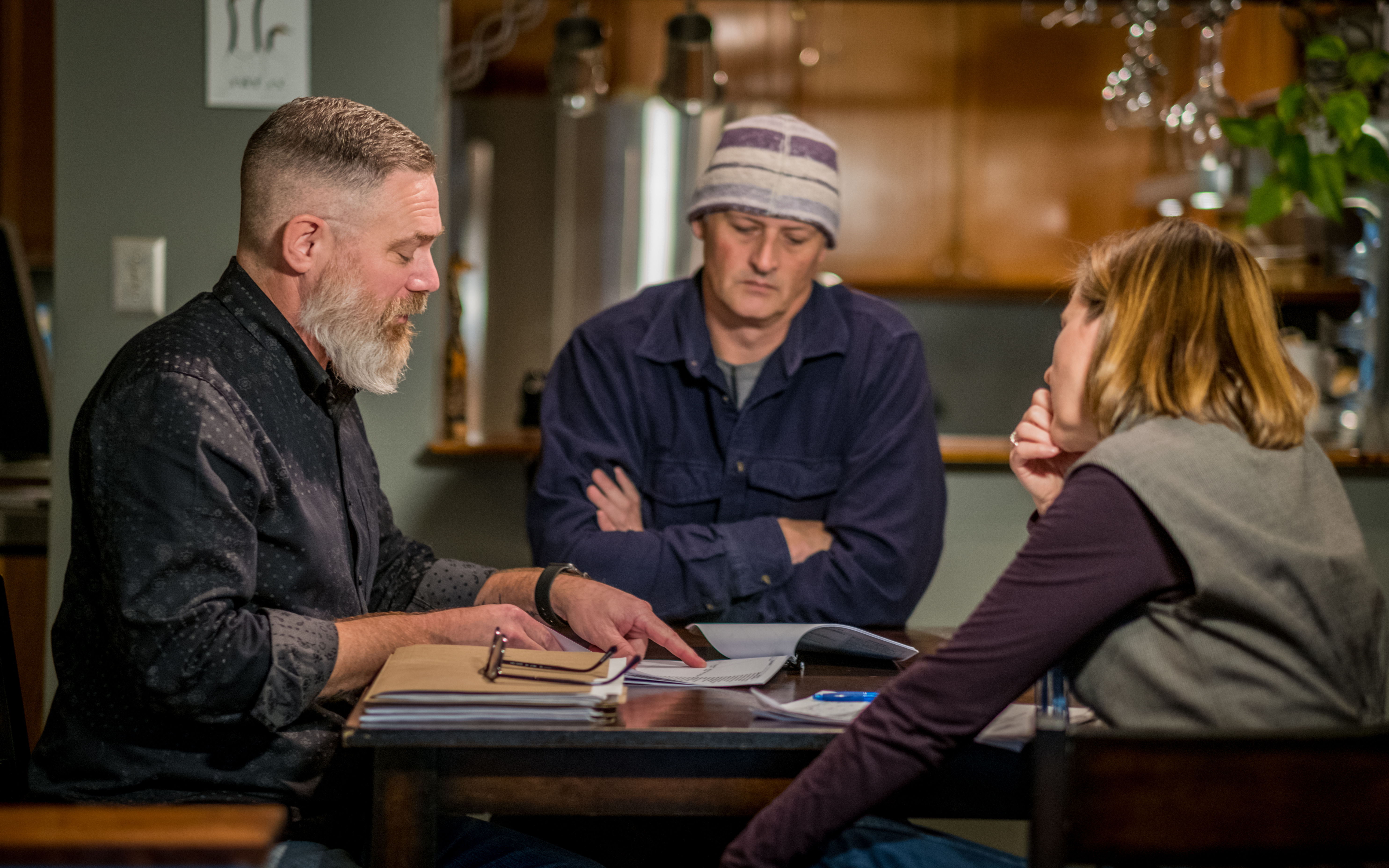 Podcast host Julie Ireton, right, sits down with Peter Hamer, left, and Marc Leach, centre. (Michel Aspirot/CBC)