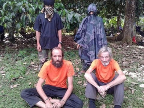 Hall, right, and Norwegian hostage Kjartan Sekkingstad are seen in this undated picture released by Abu Sayyaf to local media in 2016. (Reuters)