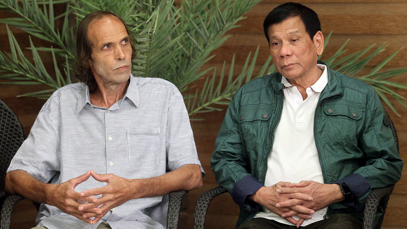 Sekkingstad, left, sits next to Philippine President Rodrigo Duterte in Davao City after being freed in September 2016. (Lean Daval Jr./Reuters)