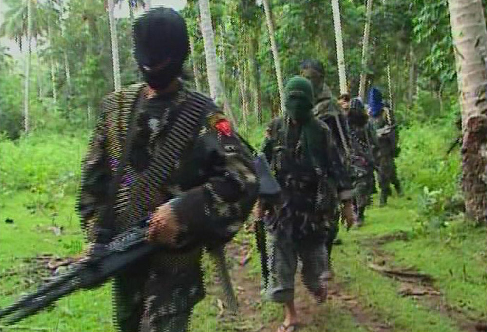 Members of Abu Sayyaf are shown moving through the jungle in a still from a video made for the kidnapping of Red Cross workers in 2009. (Reuters)