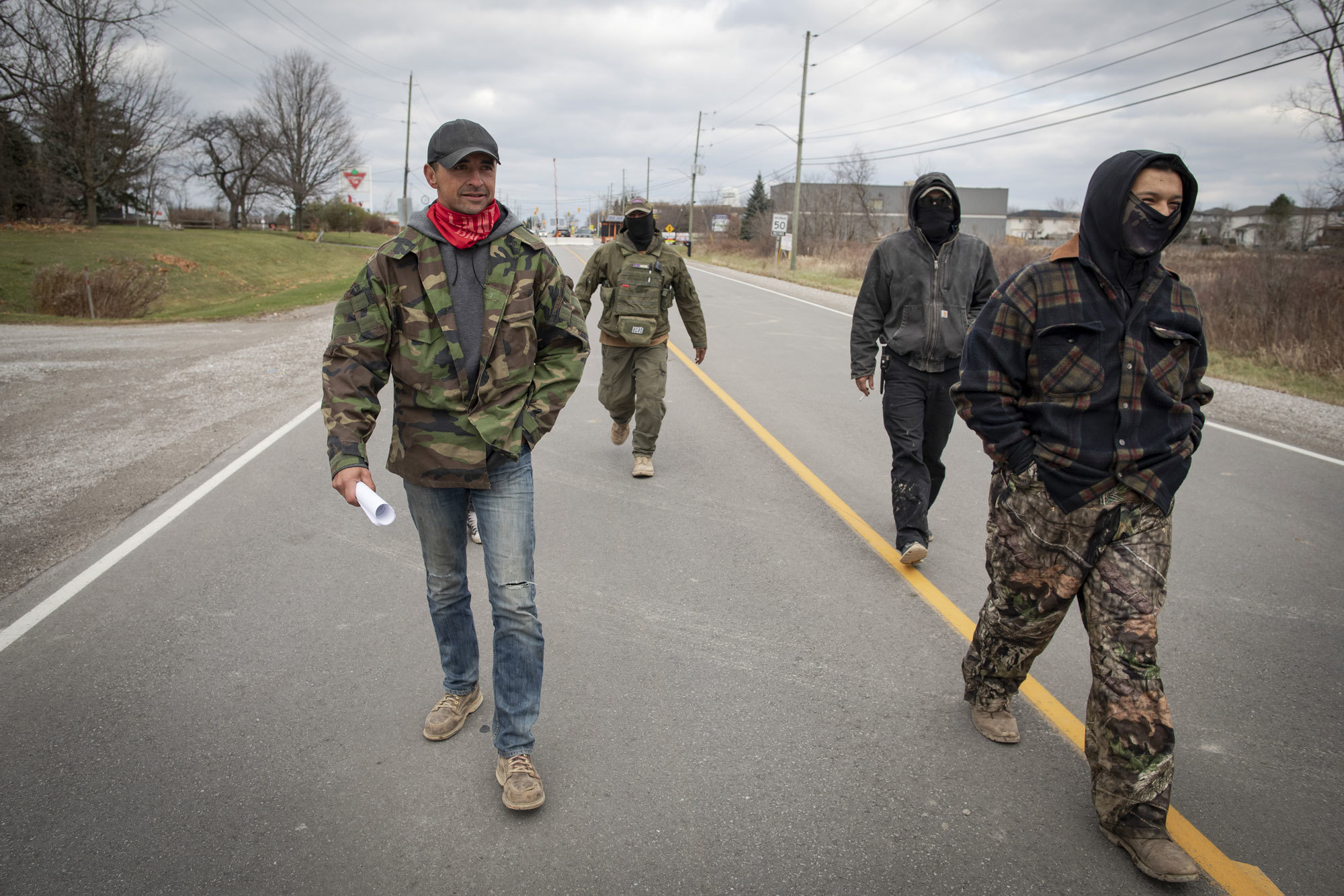 Skyler Williams, left, walks along Argyle Street South with fellow members of 1492 Land Back Lane. (Evan Mitsui/CBC)