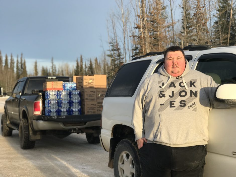 Ryan Shank stands outside of his truck at the N.W.T.-Alberta border.