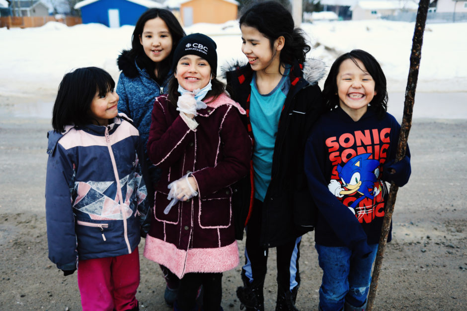 Children in Stanley Mission laugh after playing in the street together in the small town.