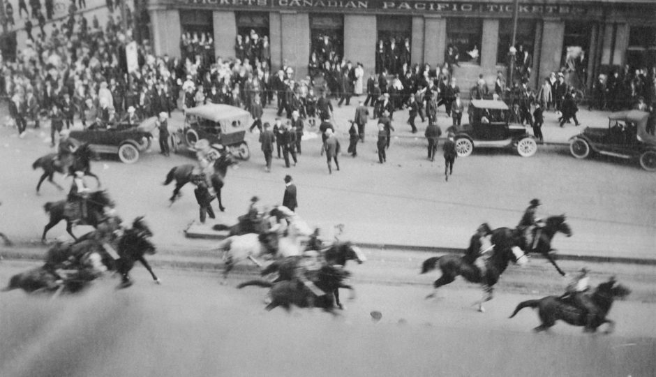 Special constables rush on horseback through a crowd at the corner of Portage Avenue and Main Street on June 10, 1919 (Archives of Manitoba)