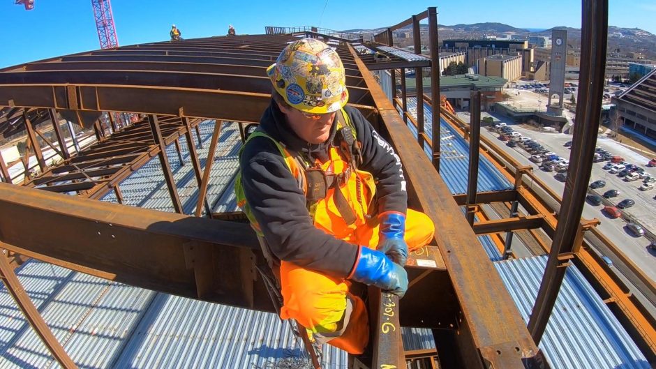 A steelworker fixes a metal beam into place at Memorial University's Core Science Facility. (CBC) 