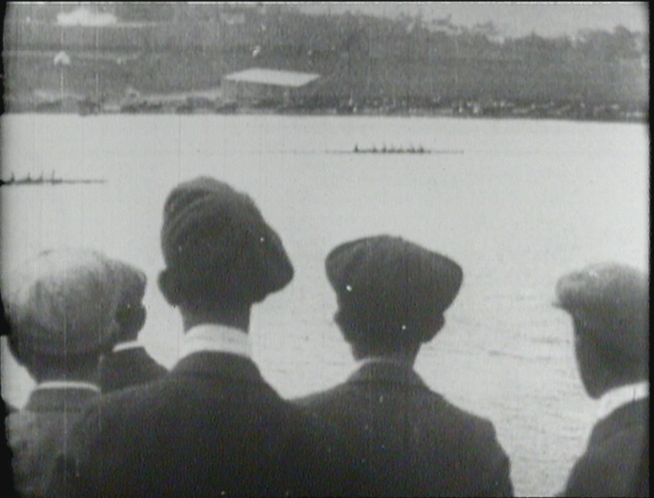 An archival photo from the early 1900s as some young men watch the rowers in the Royal St. John's Regatta at Quidi Vidi Lake.