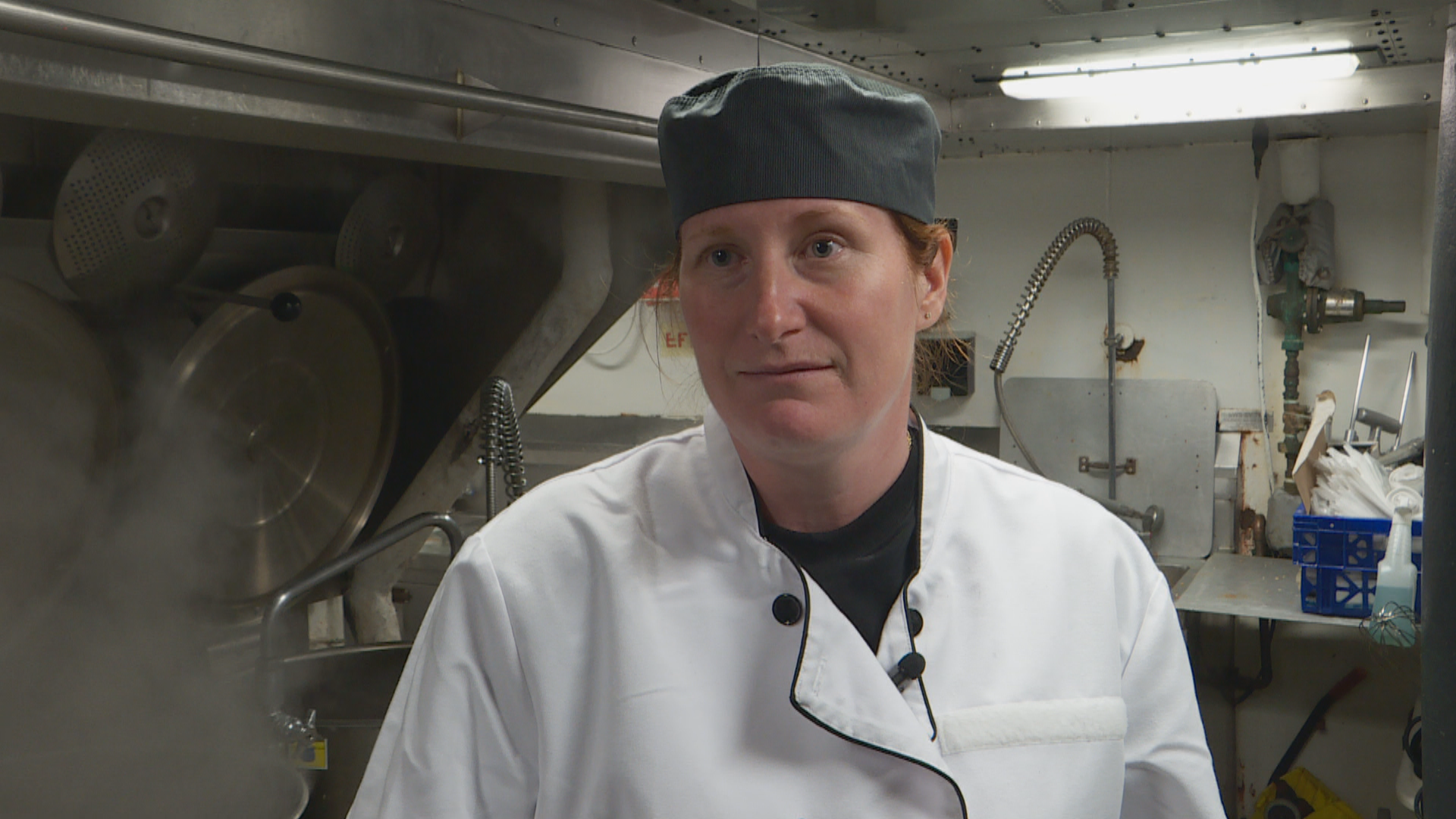 The head cook, Lisa Jean Roberts, is in the kitchen preparing a special dinner hosted by the captain for members of parliament who are on board for a visit. (Peter Cowan/CBC)