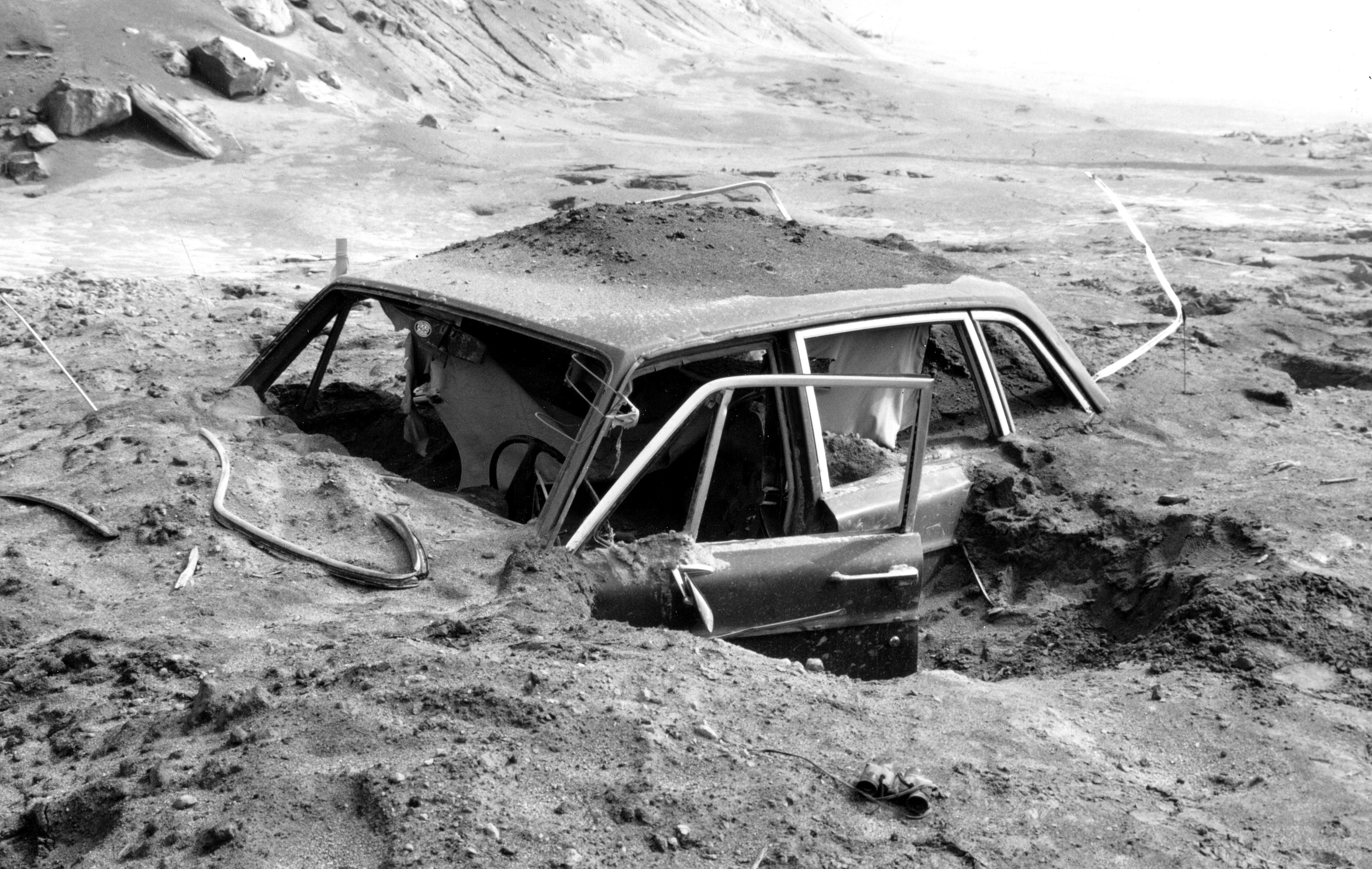 A car more than 10 km northwest of Mount St. Helens' summit lies buried in more than a metre of volcanic ash on May 18, 1980. (U.S. Geological Survey)