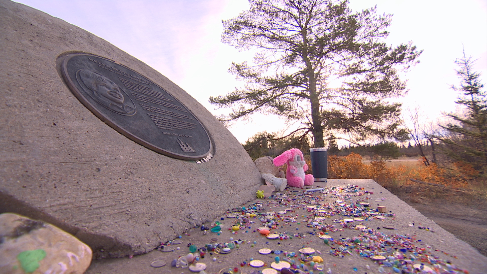 Stuffed animals, beads and coins line a memorial to Osborne outside The Pas, Man. (Jaison Empson/CBC)