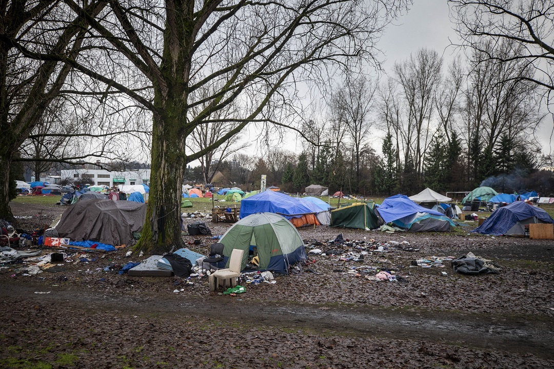 An estimated 200 campers are currently living on top of mud and amid garbage while waiting for other housing options. (Ben Nelms)