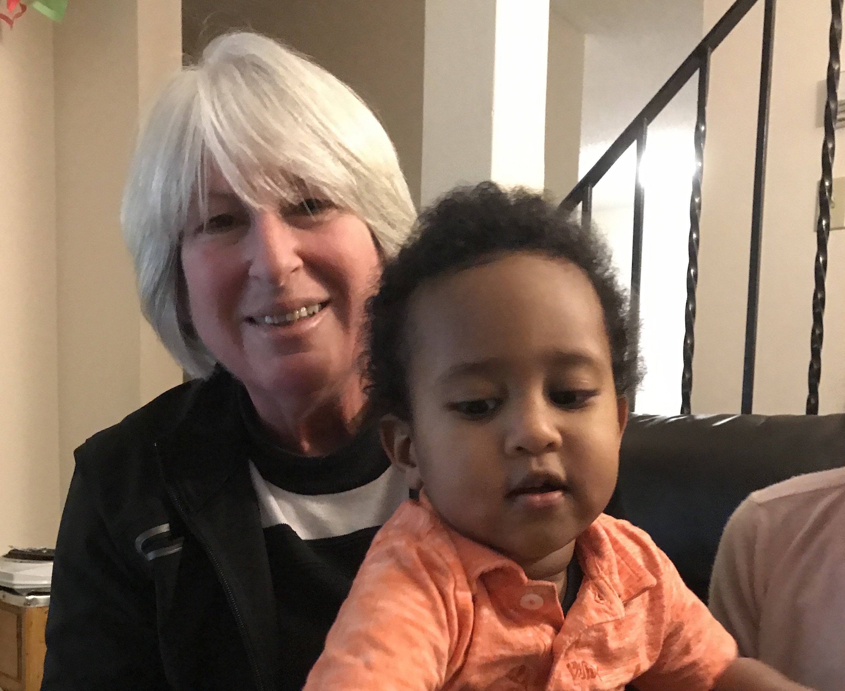 Mona Durkee holds Zechariah Tesfamichael in her lap. (Randi Beers/CBC)