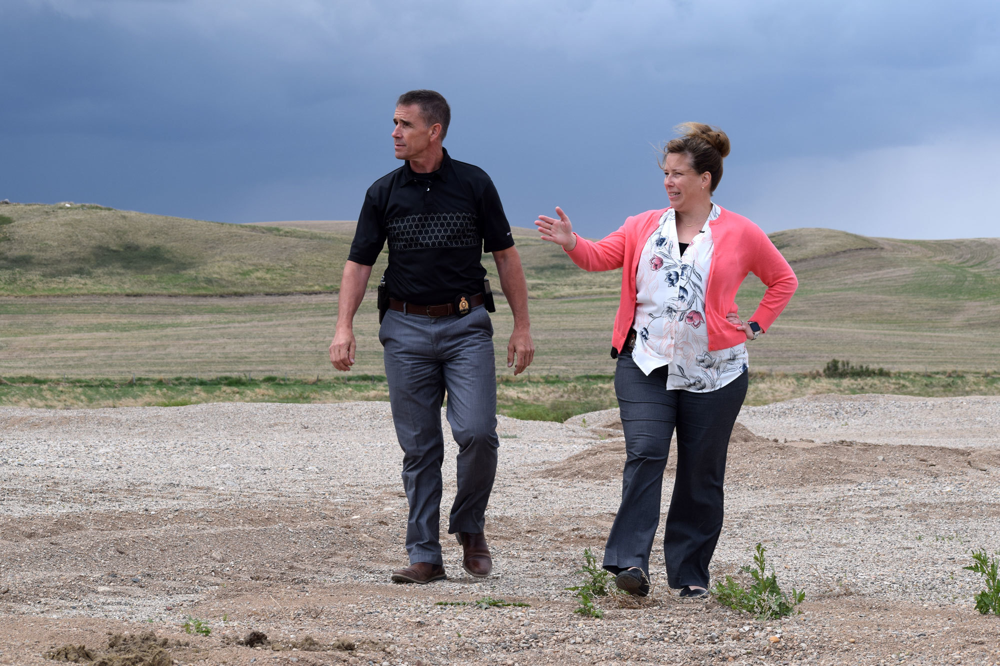 Const. Ron Degooijer, right, and Corp. Pascale Lauriault explore the gravel pit in June. (Alicia Bridges/CBC) 