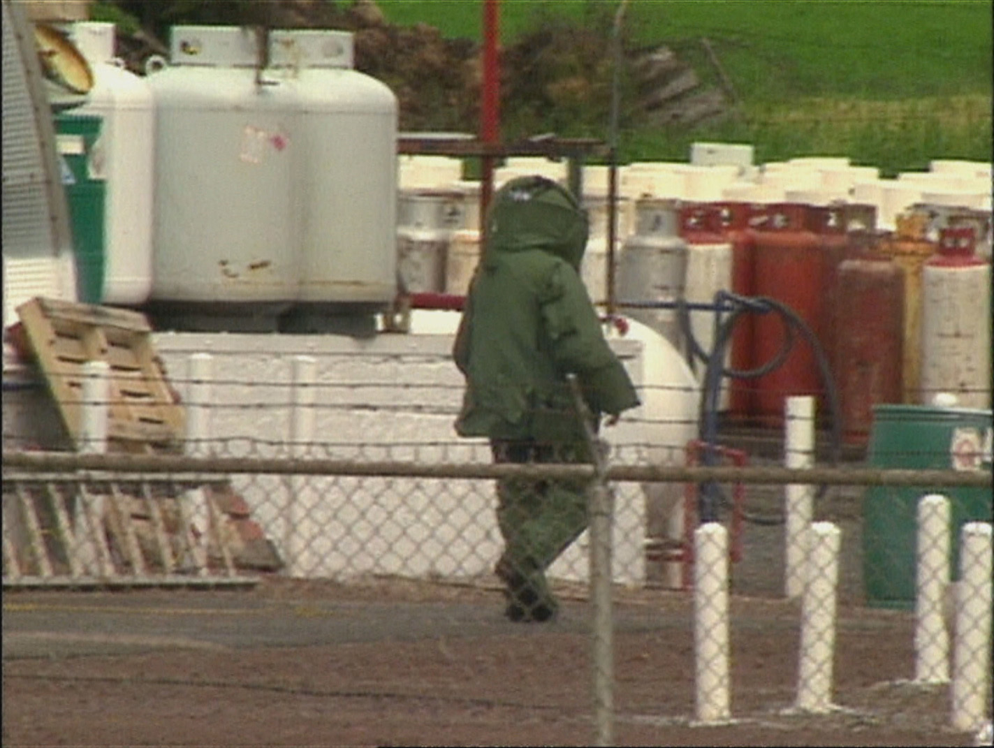 A member of the bomb squad approaches the device at the propane tank station in Charlottetown. (CBC)