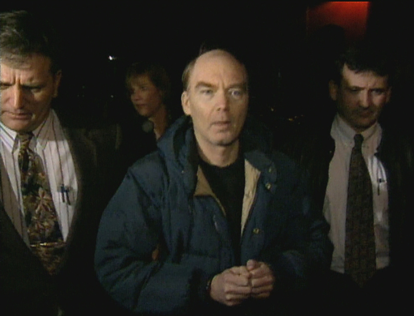 Roger Bell, flanked by Charlottetown police, after his arrest in December 1996. (CBC)