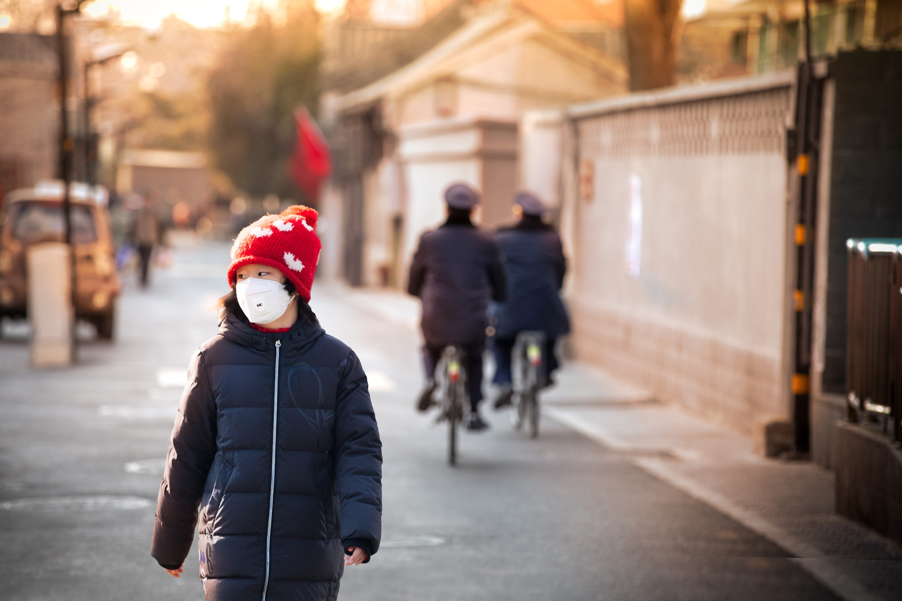 A girl walks the old backstreets of Beijing as COVID measures were implemented in January. At the time, police patrols were increased throughout the city. (Saša Petricic/CBC)