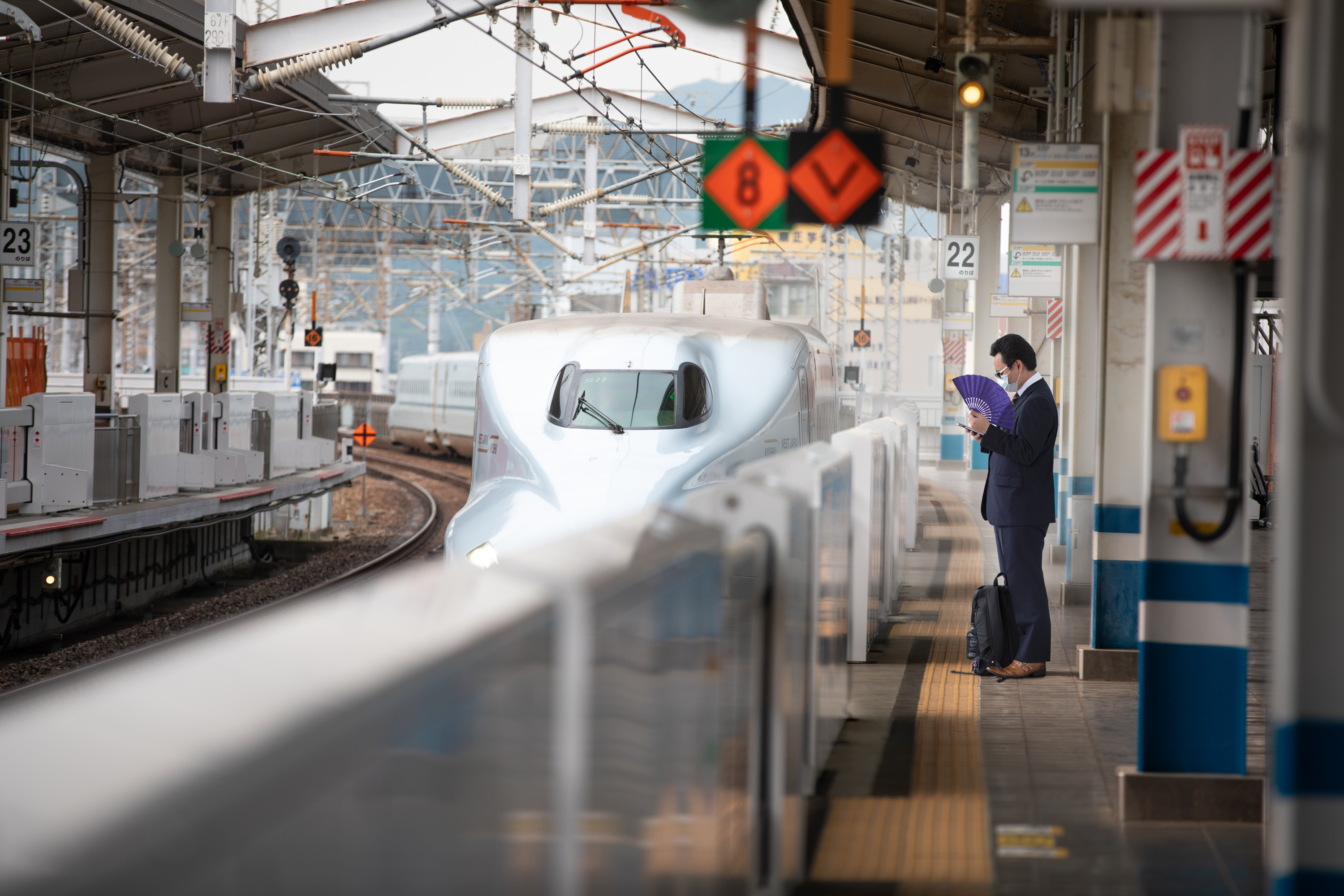 Tokyo’s busy Shinjuku shopping district emptied in May as store owners and customers voluntarily turned to social distancing. Japan’s popular bullet train was also almost deserted in May. (Saša Petricic/CBC)